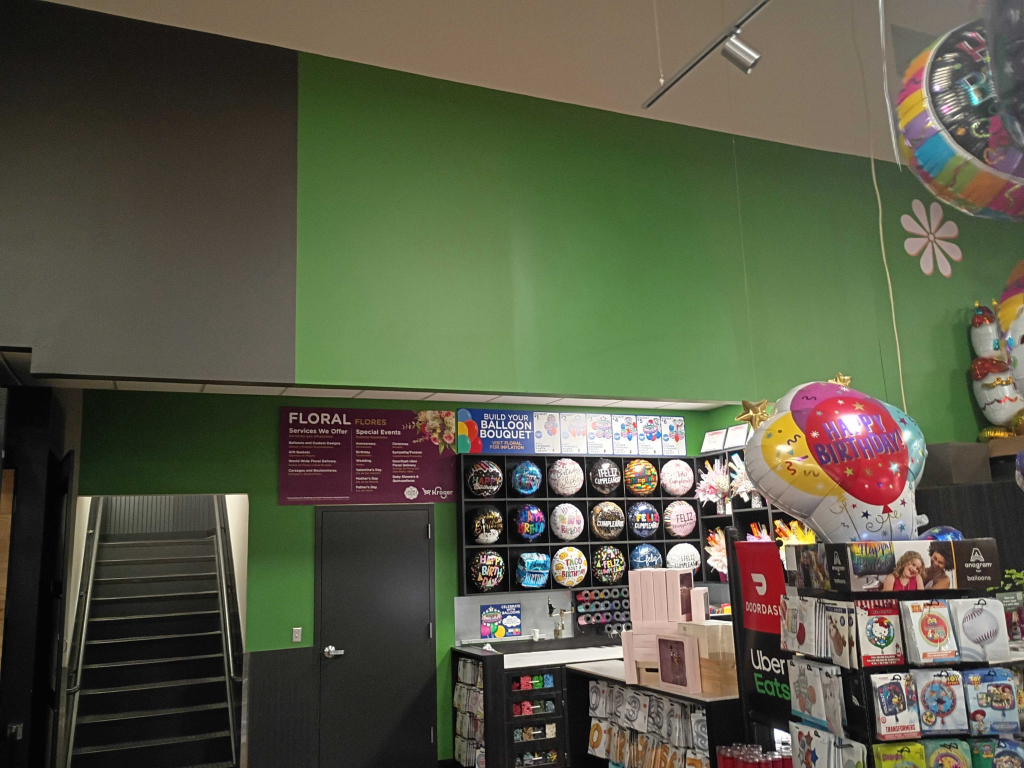 Floral department with green painted walls and balloon display