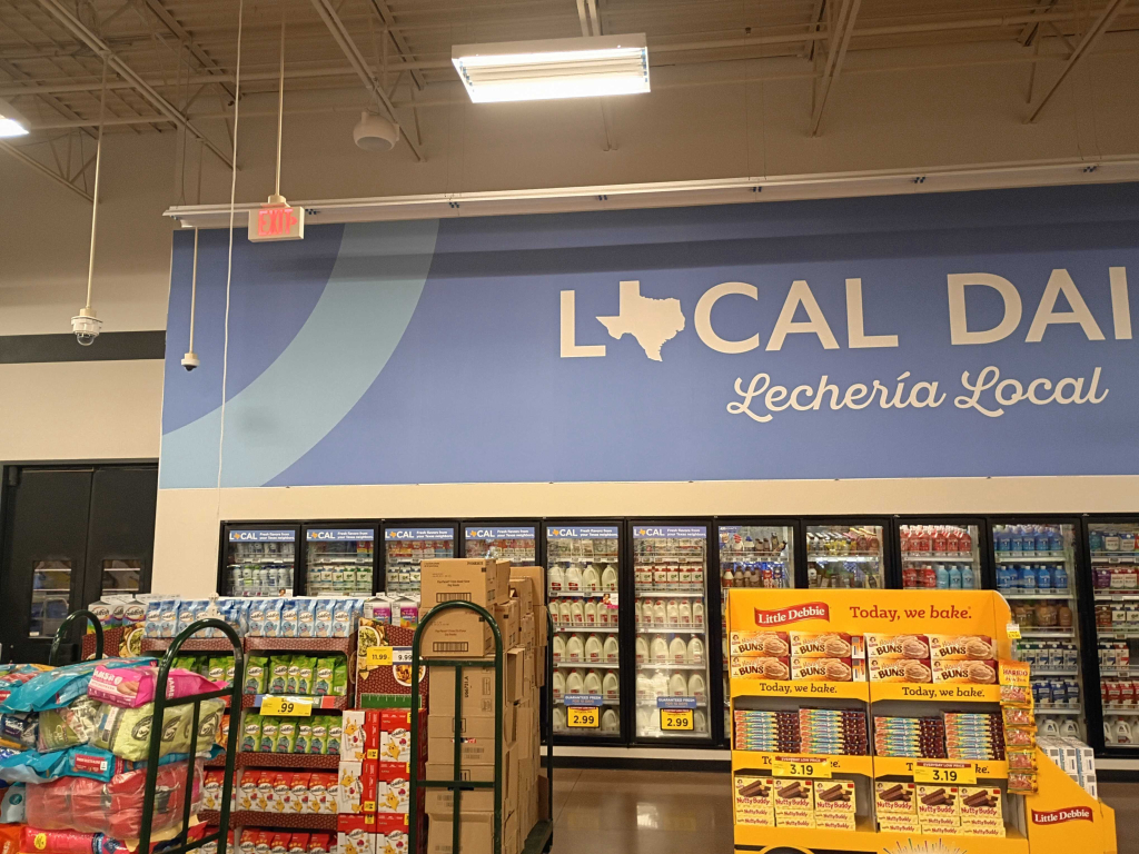 Spanish Local Dairy wall graphic over cooler cases